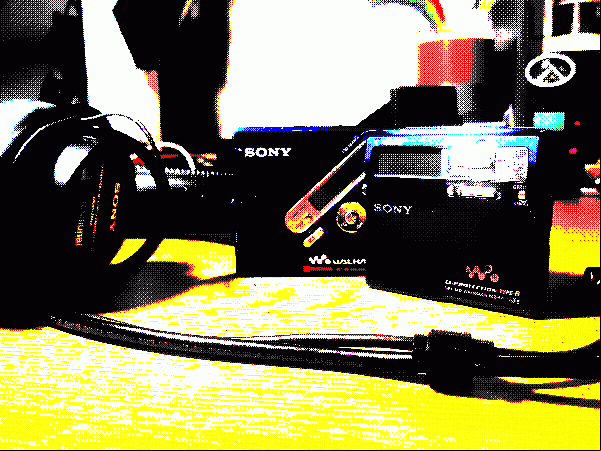 two sony minidisc players, next to a pair of sony headphones