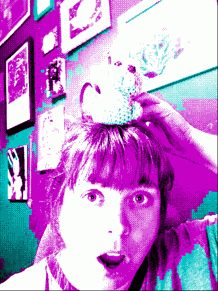a woman with surprised face holding a crochet toy on her head